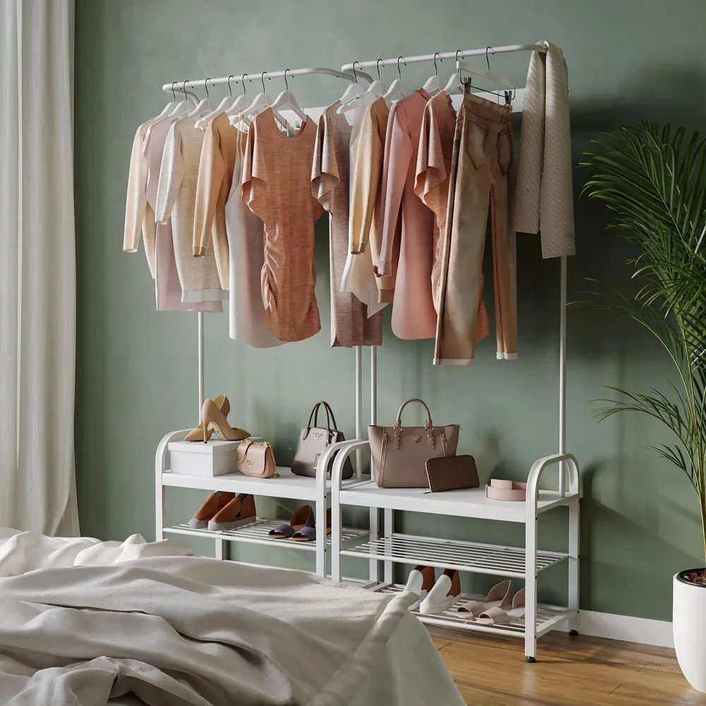 3D visualization of a clothing rack with pastel outfits, handbags, and shoes in a bedroom corner