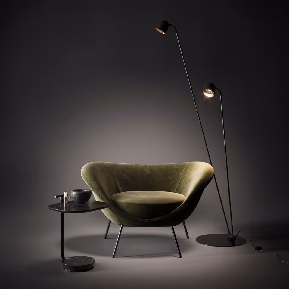 3D rendered image of a stylish green chair with a floor lamp and side table, showcasing first-class product visualization and photorealistic rendering.