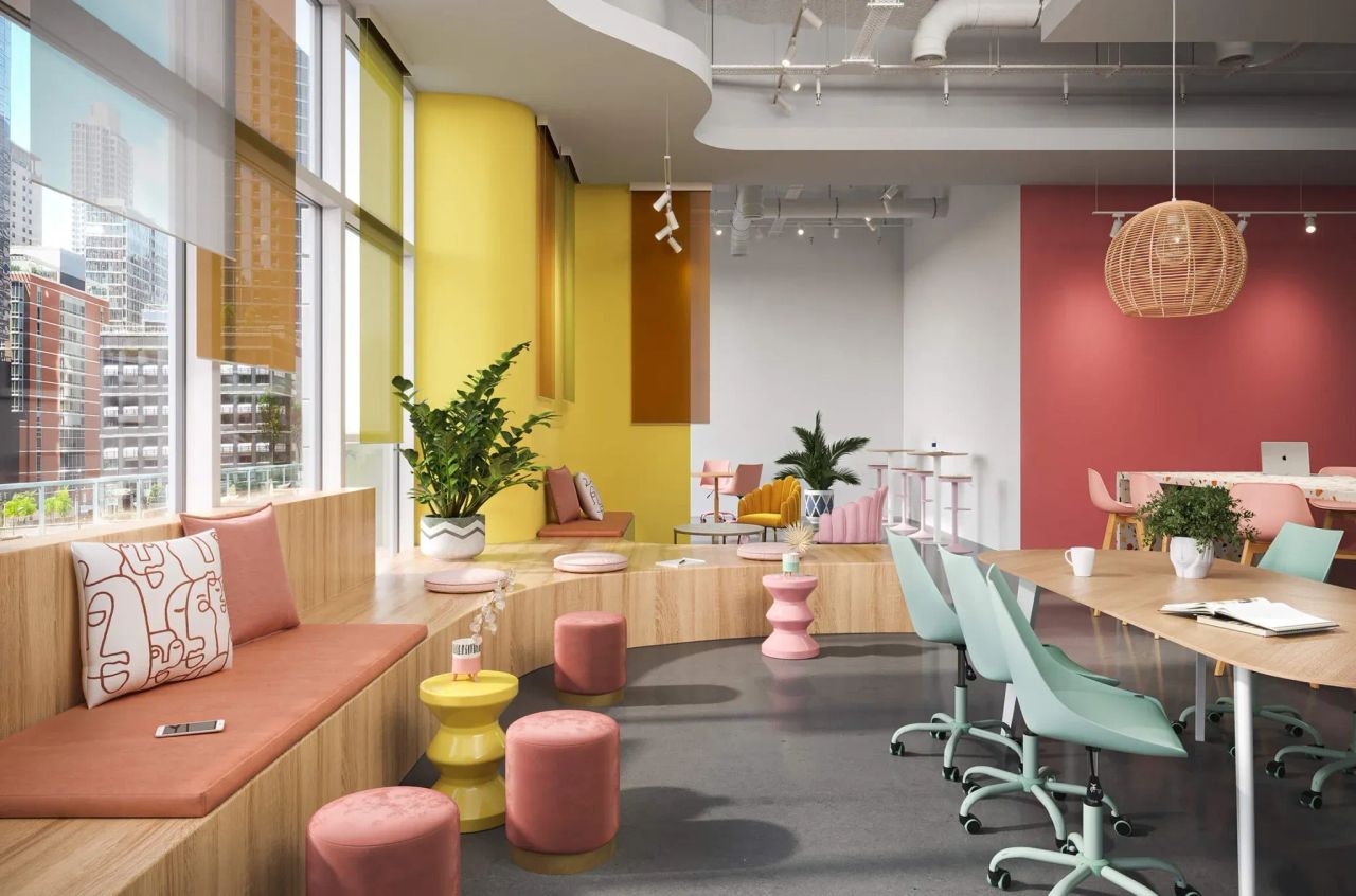 3D visualization of modern office with colorful walls, seating, shared desks, and pendant lighting